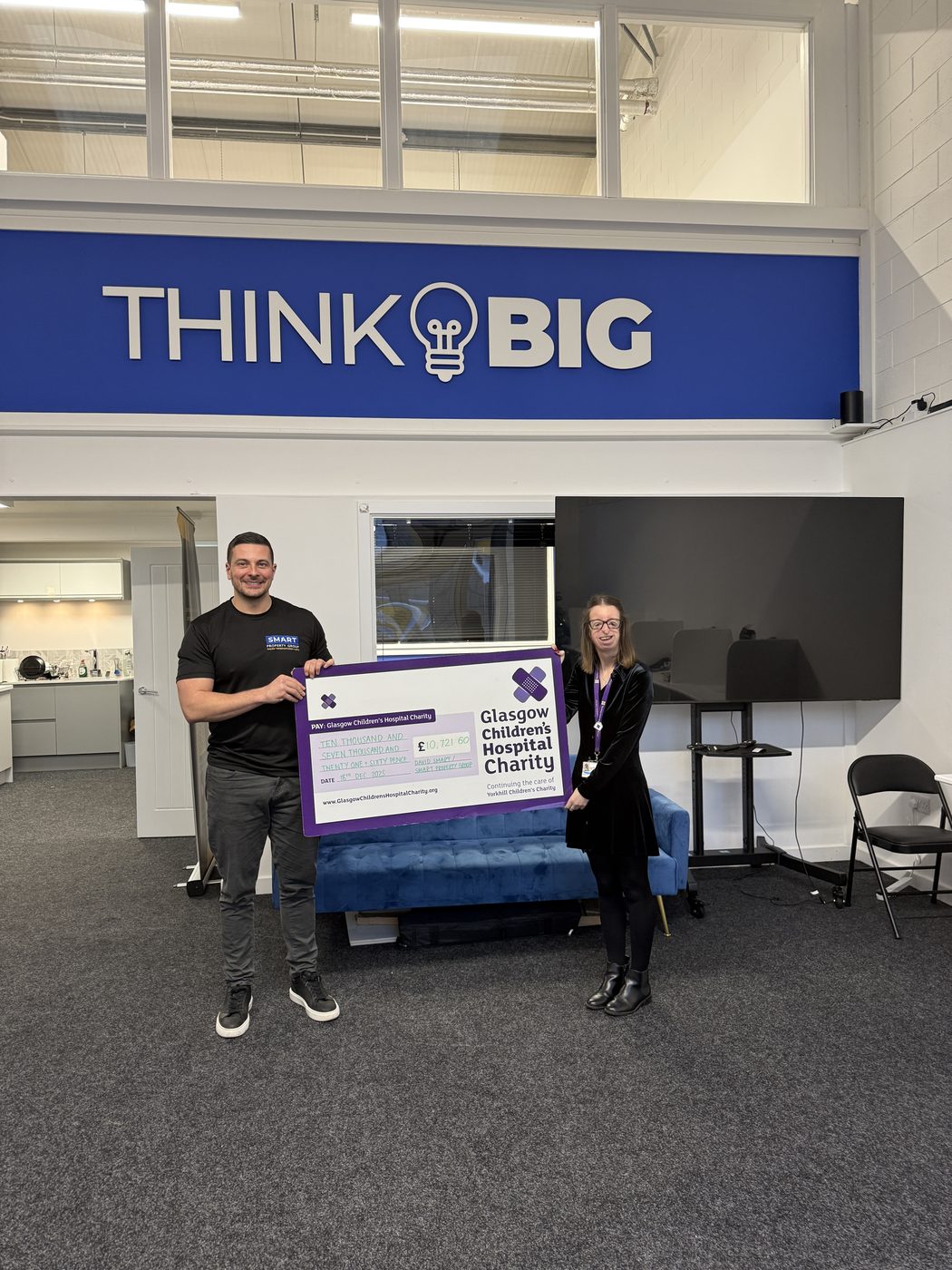 David Smart presenting the cheque to a representative from Glasgow Children's Hospital Charity